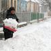 Havat lapátol egy nő Szepetneken. Az ország nyugati részén további havazásra, az Észak-Dunántúlon az erős szél miatt hófúvásra kell számítani.