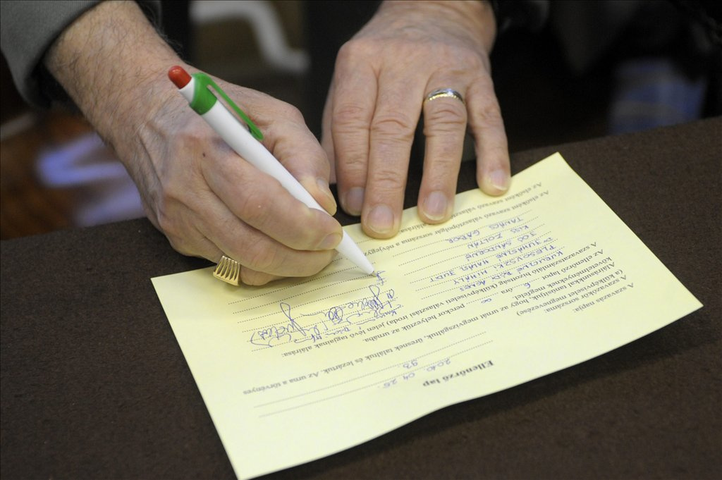 Egy választópolgár borítékba teszi a szavazólapot a szavazófülkében.