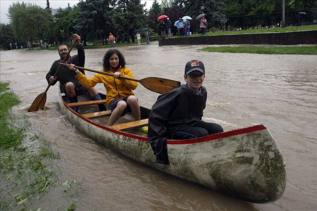 Emberek csónakkal közlekednek Miskolcon a Kilián városrészben, miután az esőzések következtében megáradt és kiöntött a Szinva patak.