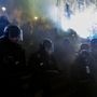 The police reacted to the smoke grenade by sending in reinforcements in riot-gear.