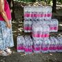 Az Otthonunk Nagytarcsa civil szervezet aktivistái saját büdzséből vásárolt ásványvíz kartonokat osztanak a nagytarcsai Petőfi telepen