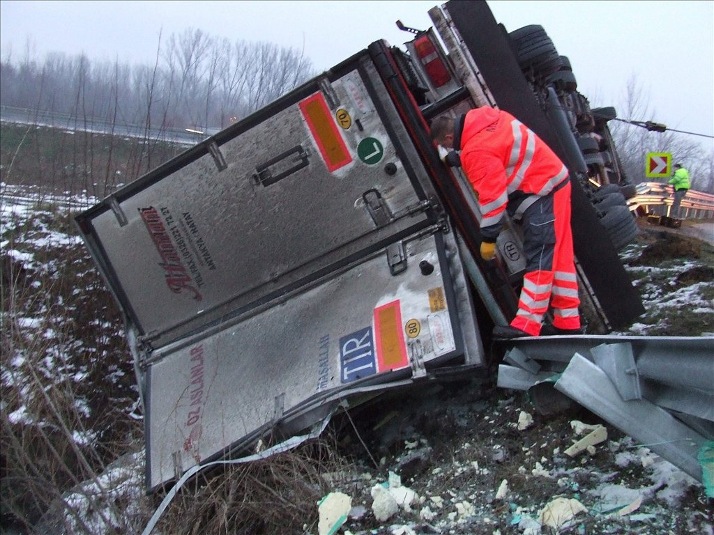 A 20 tonna húst szállító jármű valószínűleg a sebesség helytelen megválasztása miatt csúszott meg és borult az oldalára.