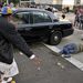 Egy tüntető fekszik az utca kövén, akit a bíróság épületéből kitolató rendőrautó ütött el. 