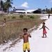 Gyerekek játszanak Kiribati nemzetközi repülőtere mellett. Az országba csak két légitársaság közlekedik: az Air Nauru és az Air Marshall Islands.  
