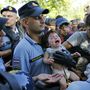 Síró gyermeket emelnek ki a horvát rendőrök a tömegből. 
