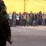 A menekülő civilek közül kiemelt férfiakat sorakoztatják fel kormánypárti katonák egy aleppói rendőrség udvarán.