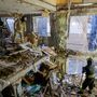 Mentőcsapat távolítja el a törmeléket egy megrongálódott épület lakásaiból Donyeckben 2022. december 6-án