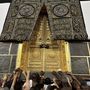 Muzulmán zarándokok megérintik a Nagy Mecset közepén álló Kába-szentély falát a szaúd-arábiai Mekkában 2023. június 25-én.