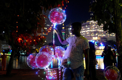 Buddhista hívők követik a kocsik felvonulását a Vesak-napi felvonulások során Malajziában 2025. május 12-én