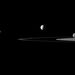 A képen a Szaturnusz, a sávokból álló gyűrűrendszer, és a 38 holdból öt látható (Janus, Pandora, Enceladus, Rhea, Rhea, balról jobbra haladva).