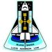 STS-43, Atlantis, 1991. augusztus 2. Egy TDRS műhold pályára állítása, a TDRS szatelitek az űrhajókkal való kapcsolattartást szolgálják. A jelvény egy Erlenmeyer-lombikot formál, az űrsikló orránál a csillagok a 43-as számot jelenítik meg.